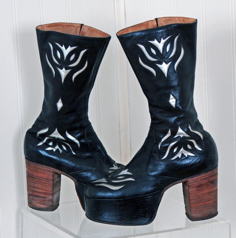Amazing 1970's custom-made leather boots in the most incredible metallic-silver and black color combination. These boots have stacked wood-heels with a leather-covered high platform. I love detailed cutwork and ankle-length. Boots like these will