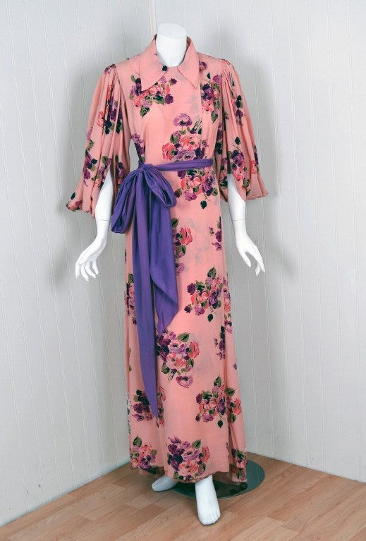 The breathtaking pink and purple colors used in this 1930's silk-rayon dressing gown has a fresh innocence that I find irresistible. The bodice is a collared side-button design that falls into the most beautiful winged angel-sleeves. The stylized