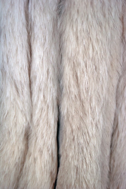 This exquisite 1960's ivory-blonde genuine mink fur coat will make any woman shine during the upcoming cold winter months. The soft mink has been worked into an almost faint striped pattern and the effect is really breathtaking. The care to piece