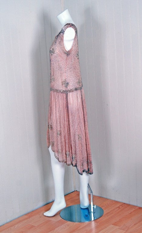 There are lots of lovely 1920's garments still around, but every once in a while I come across one that sets my heart a flutter! This is an extraordinarily beautiful and exceptional 1920's champange-pink beaded silk-chiffon dance dress. It is