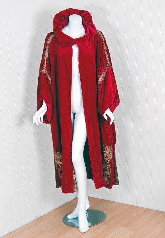 Madeleine & Madeleine of Champs-Elysees Paris was one of the elite couture houses operating during the art-deco era. This breathtaking garment, all hand-stitched, is fashioned in vibrant magenta silk-velvet and metallic gold-lame. The embroidered