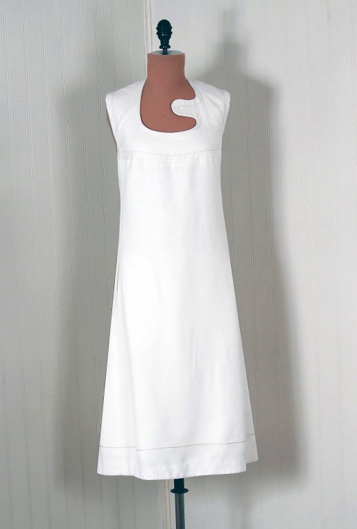 Spectacular mid 1960's Pierre Cardin designer dress in crisp-white lined cotton-linen. In 1951 Cardin opened his own couture house and by 1957, he started a ready-to-wear line; a bold move for a French couturier at the time. The look most associated