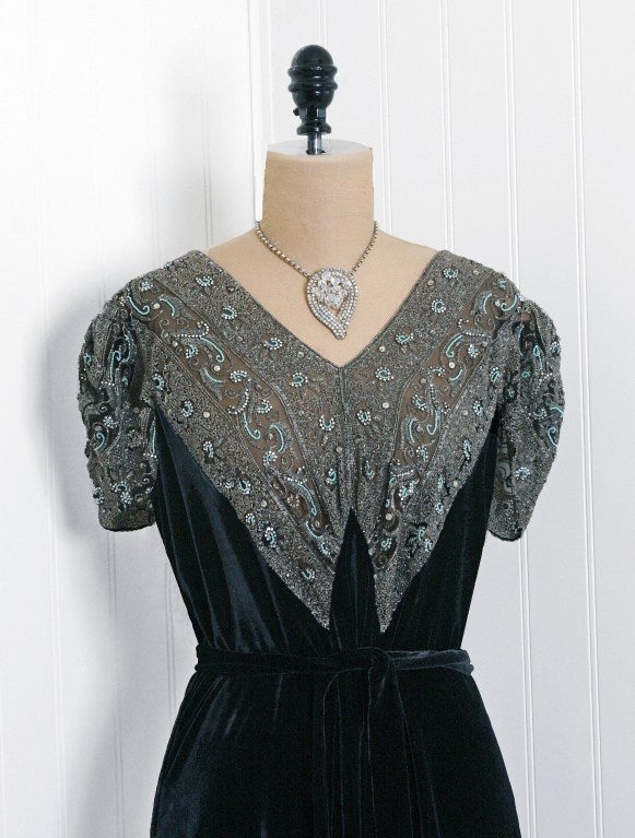 A stunning Registered Original Design black silk-velvet gown from the 