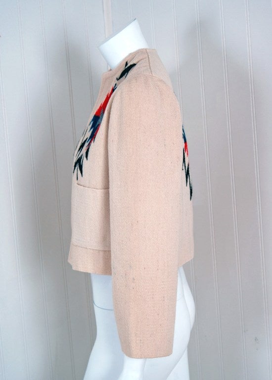Highly sought after collectible 1940's Chimayo Native-American souvenir jacket in a stylish cropped silhouette. The ivory-creme hand woven wool is thick & plush, great for those chilly nights! Beautiful colorful Navajo designs on front bodice &