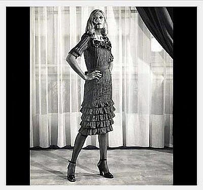 This exquisite black silk-taffeta cocktail dress is from the infamous 1971 Fall-Winter Yves Saint Laurent Haute-Couture collection. The seductive bodice features a ruffle trimmed low-cut plunge. The finely pintucked fabric really gives the garment
