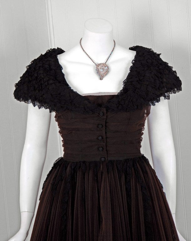 The House of Dior has been an enduring icon of haute couture. When the talented Yves Saint Laurent took over as head designer, he continued the Dior tradition of elegant design. This beautiful chocolate-brown pleated tulle & black lace party dress