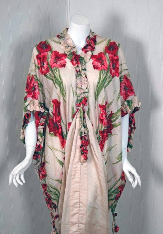 Heaven on earth! With its wide angel-sleeves and breathtaking silhouette, this rare garment makes a memorable impression.  The art-nouveau floral print is unbelievable; the brilliant colors cannot be matched today. It has the most flattering cut