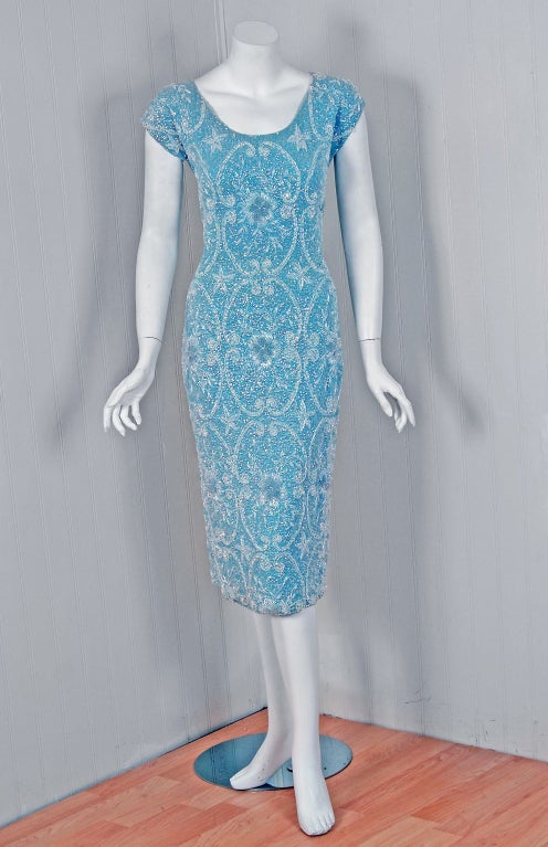 1950's Gene Shelly designer garments are in a class of their own. They are always fully-sequined by hand and fit to flatter the figure. This treasure has a fantastic abstract-garden design worked in, featuring iridescent-beadwork around