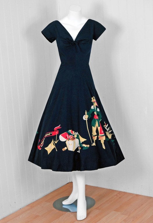 This is perhaps the most darling and flattering 1940's sun dress I have ever seen. Fashioned from navy-blue cotton, this 