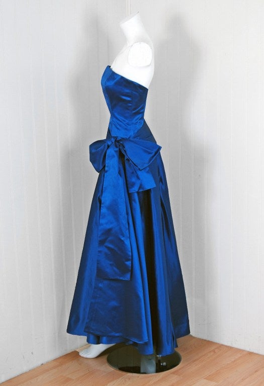 The House of Dior has been an enduring icon of haute couture. When the talented Marc Bohan took over as head designer in 1960, he continued the Dior tradition of elegant design. This breathtaking sapphire-blue gown ensemble is a perfect example of