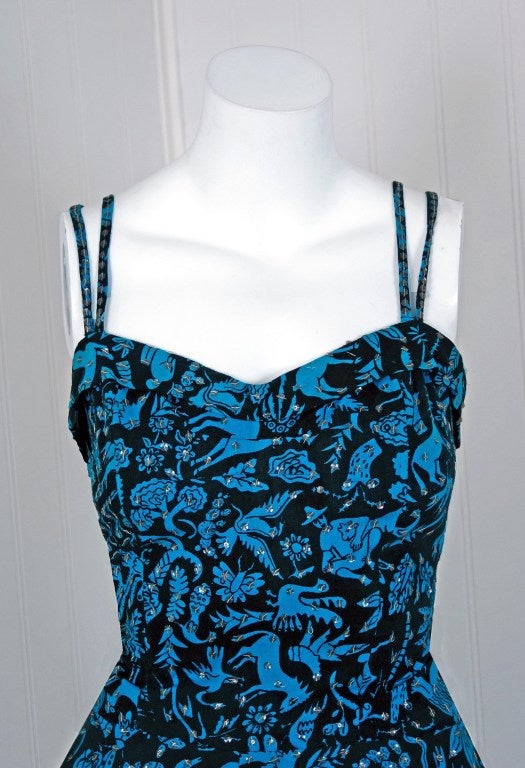 With its vivid turquoise-blue sequin print cotton and flawless silhouette, this sundress has the casual elegance the 1950's were known for. The animal-novelty pattern is hand screened onto the fabric and is one of the best designs I have seen from
