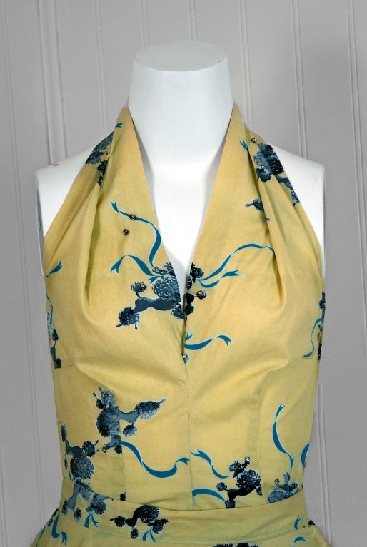 With its adorable poodle novelty-print and flawless styling, this garment has the casual elegance the 1950's were known for. The low-cut plunge halter blouse is very flattering and effortless to wear. The hourglass nipped waistline is both ladylike