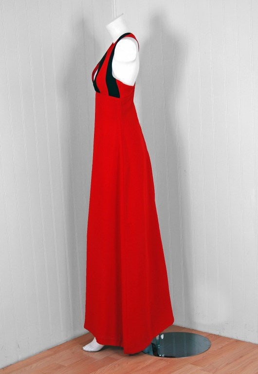 A stunning Vera Mont Paris maxi dress, a desirable and collectable vintage label founded during the 1960's in France. This garment, dating back to the mid-1970's, is fashioned with vibrant ruby-red and black fully lined rayon crepe. The bodice is a