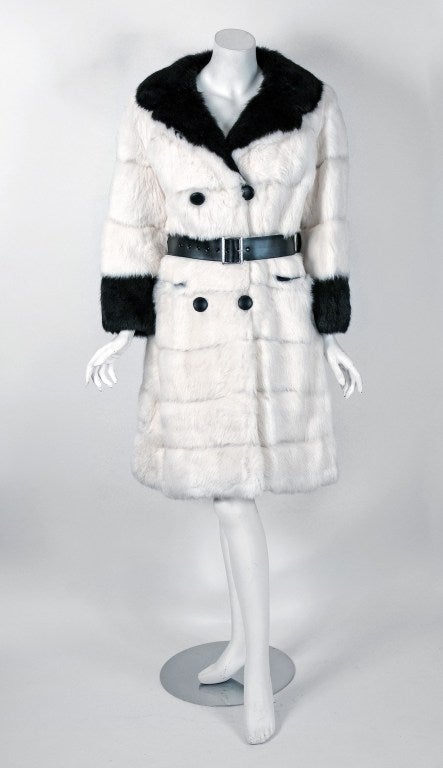 Stunning 1960's winter coat in the most fabulous black & white genuine rabbit-fur. The beautiful two-tone color combination is so fresh and modern. I love the double-breasted bodice and long,lean sleeves. Shaped with princess-line seams that flare