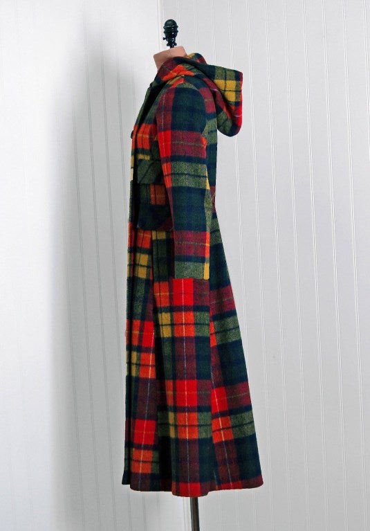 This breathtaking and ultra-chic mid 1970's rainbow-plaid wool will make any woman shine during cold snowy months. I love the double-breasted, side ticket-pockets hooded bodice and long,lean sleeves. Shaped with a-line seams that flare out in a