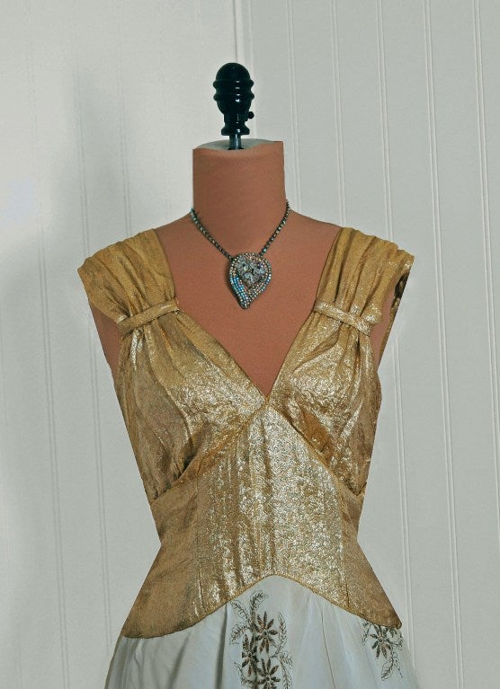 The breathtaking metallic gold-lame used in this 1930's evening gown has a seductive quality that I find irresistible. The bodice is a dramatic low-cut plunge sculpted shelf-bust. The nipped waist hourglass bias-cut flows into the most beautiful