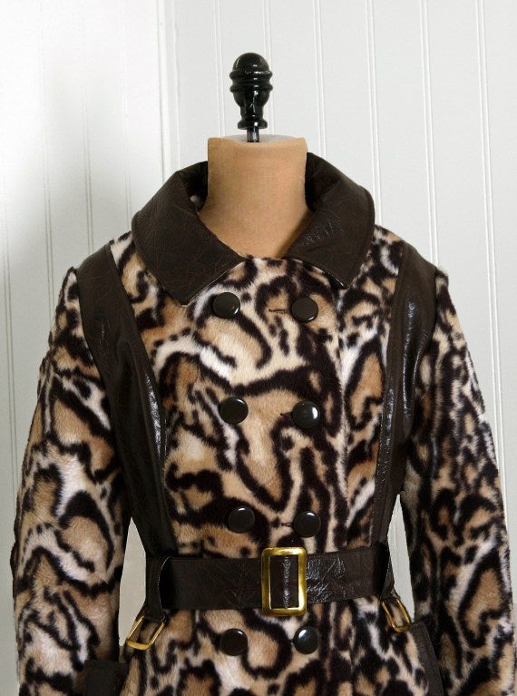This is an absolute gorgeous 1960's leopard-print coat fashioned from the highest quality faux-fur. This garment has a thoroughly modern cut and beautiful color-palette. I love the double-breasted bodice, side-pockets and tailored a-line silhouette.