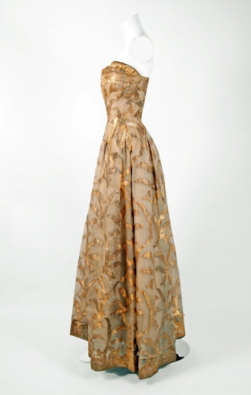 Breathtaking metallic gold & champagne silk-lame gown created by Italian designer Fernando Sarmi when he was head designer for Elizabeth Arden in the 1950's. Ferdinando Sarmi expressed interest in fashion during his youth but was discouraged from