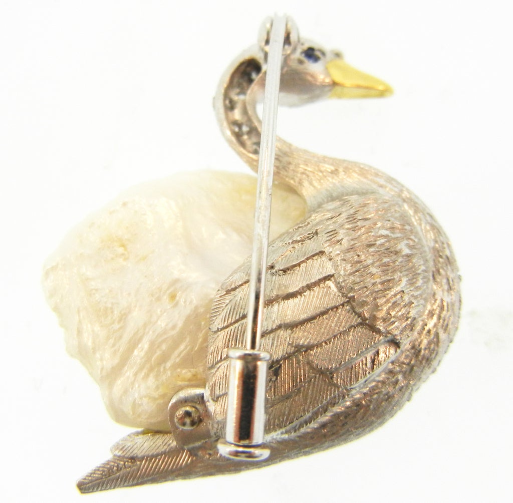 Magnificent Swan Brooch signed E.W. & Co. Showcasing a Baroque Pearl, Platinum & Diamonds. 18K Gold Beak with Sapphire Eye. Wonderful Feather Engraving on the Reverse.