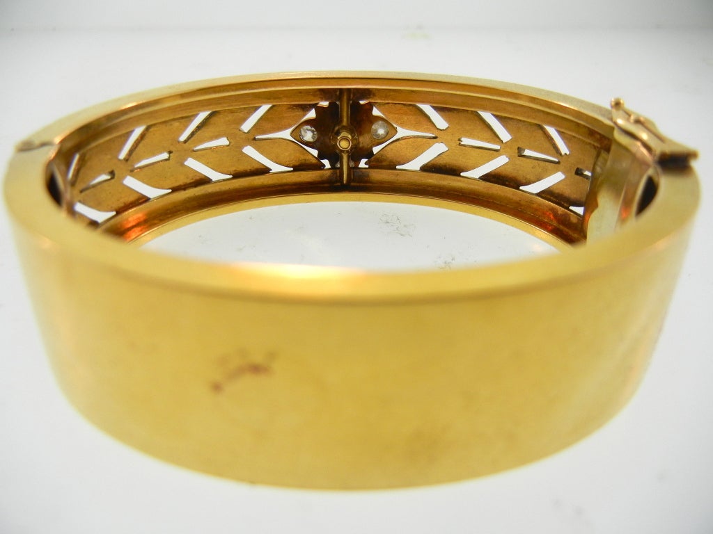 A Victorian boxed bangle with diamond and pearl floral motif in original box.