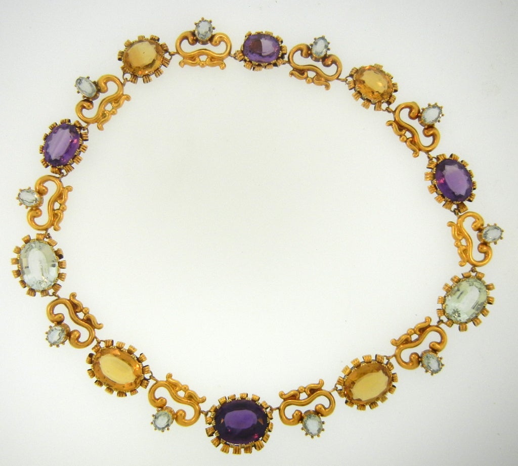 Wonderful example of late Georgian repousse work. Gold necklace set with aquamarines, citrines, and amethysts.