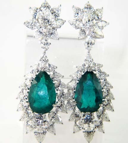 This is a stunning platinum chandelier earrings with an Emerald center stone weighing 21.5 carats and pear shape diamonds weighing 36 carats. F1 color, VS clarity.