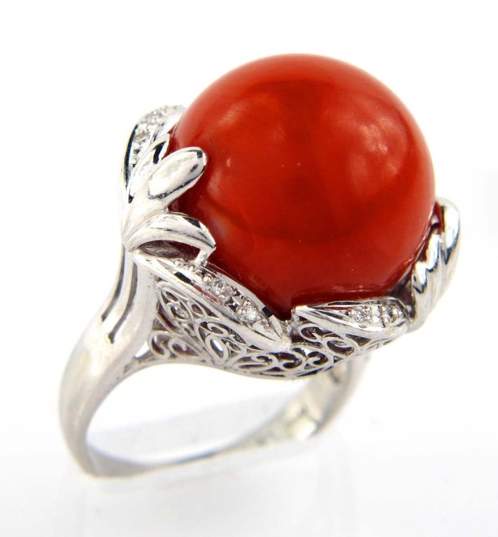 Coral Diamond and Platinum Ring. The total ring weight is  19.3 grams. The size of the ring is 8.5