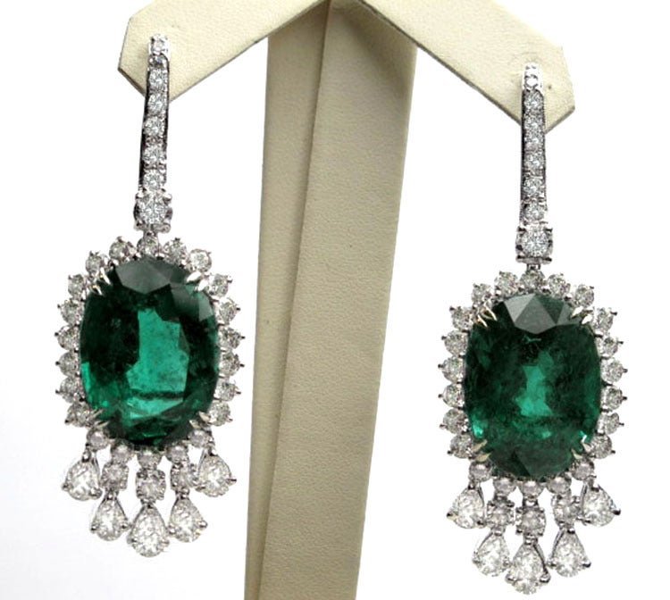 Platinum Diamond Emerald Earrings.The weight of the diamond is 9.29 carats and the weight of the emerald is 43.58 carats.