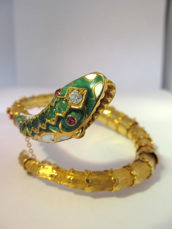 Superb wrap around snake bracelet with vivacious enamel, emerald, ruby and diamond enhanced details.
Fabulous piece to ware. Feels wonderful on.