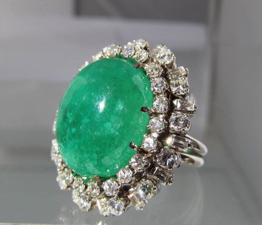 Superb large emerald cabochon set with aprocimately 3cts or diamonds in and elegant 18K white gold setting.
Rich, chic, fabulous on.