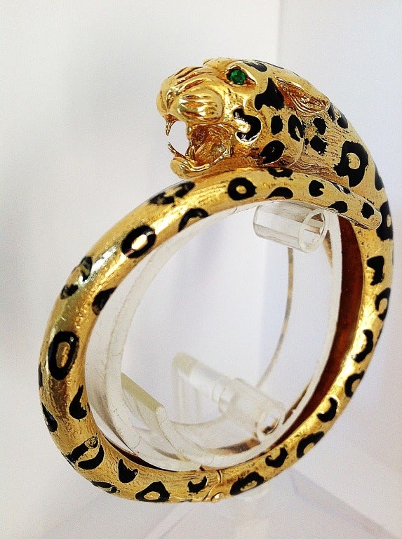 Always a classic chic, dense 18k leopard enamel bracelet, with emerald detail in mouth.
Fabulous on alone or bunched with other links or bangles, this piece has a hinge at center back, to open and close. 

( cuff, chain, bangle, retro, modern,