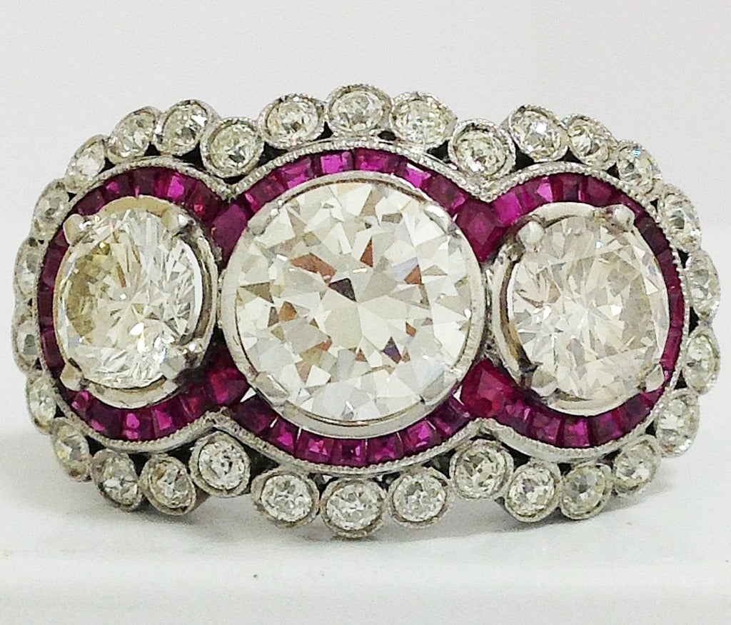 Magnificent platinum, diamond and ruby ring, with individually calibrated natural rubies channel set, with 
One aprox 2.5cts  center brilliant cut diamond, si1, N/O
Two aprox 1.20cts each sides ranging from si1 to si2 N/O
Aprox 1.20cts single cut