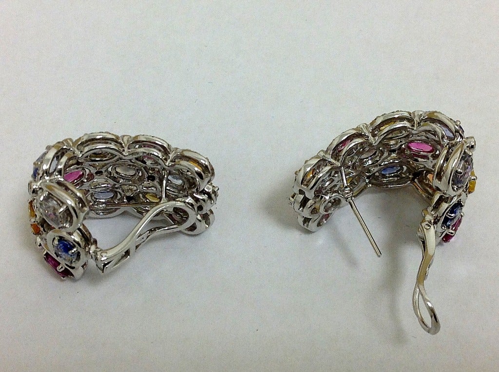 Large pair of 18 karat white gold multicolor Sapphire, And diamond whimsical earrings.
Omega backs with option of lowering the post To use as clips or omega backs. 
Fabulous on. They largely wrap around the ear. 

Studs, ear clips, Cocktail,