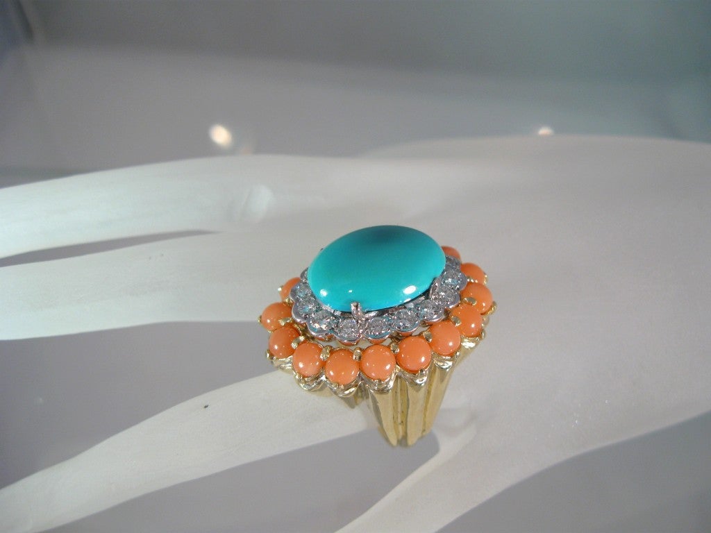 Superbly chic, Coral, Persian Turquoise Cabochon and Diamond Cocktail ring,with beautifully fluted bold yellow gold shank, diamonds set in white gold. Rich cluster of colors, great transition piece from day to night.