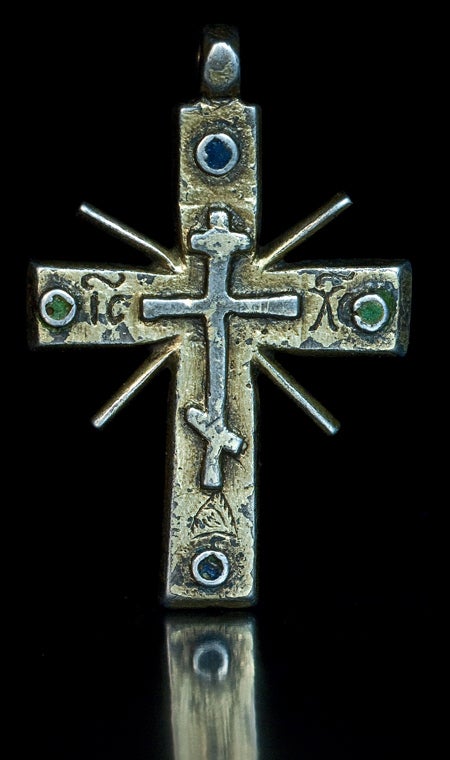 This large gilded silver and enamel eight pointed cross pendant is from the reign of Czar Ivan the Terrible (1530-1584). 

In the 16th century, Russia didn't have its own sources of silver and gold, precious metals were imported from Europe and