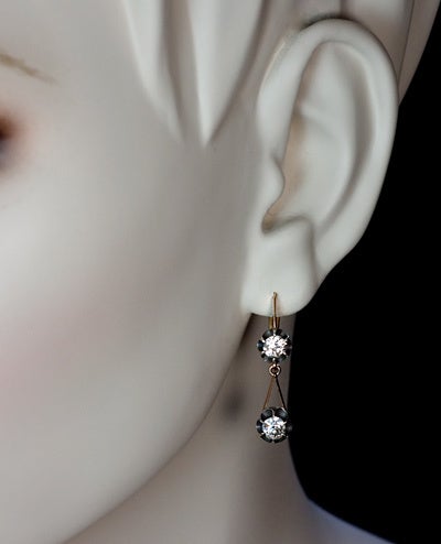 These diamond drop earrings were made in Moscow between 1908 and 1917. 

Four old European cut diamonds with an approximate total weight of 1.6 ct are set in silver over 14K gold. 

Height  - 1 3/16 in. (30 mm)

Both earrings are marked with