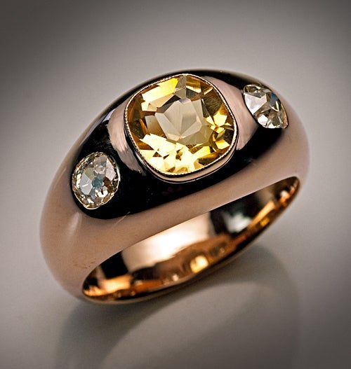 A dome shaped polished rose gold unisex ring is centered with an old cushion cut yellow citrine in a millegrain bezel (approximately 1.67 ct),

flanked by two old cushion cut sparkling diamonds (approximately 0.33 and 0.42 ct).

Width - 11