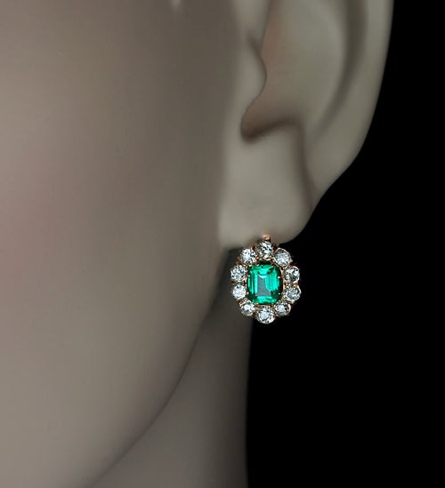 Die Ohrringe sind mit zwei leuchtend grünen Smaragden aus alten Minen (ca. 0::67 und 0::71 ct) besetzt:: die von funkelnden Diamanten im alten Schliff mit einem geschätzten Gesamtgewicht von 1::50 ct umgeben sind. 

Hergestellt in Moskau zwischen