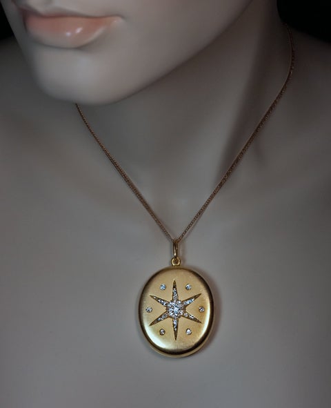 This large 14K gold locket was made in St. Petersburg between 1904 and 1908.

The matte yellow gold front cover is decorated with a diamond-set  six pointed star encircled by six diamonds.  

Estimated total diamond weight 1 carat.

Height