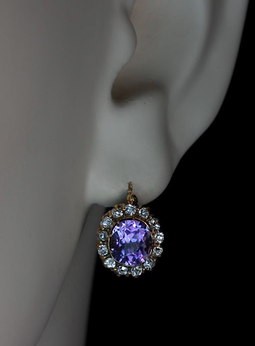 Made in St. Petersburg between 1899 and 1904.

The 14K yellow gold earrings are set with two sparkling medium purple amethysts surrounded by 26 old single cut diamonds.

The amethysts are 7 x 6.4 x 5.3 mm  and  7 x 6.5. x 5.2 mm. The approximate