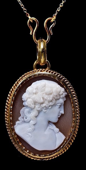 European, circa 1880, made for the Russian market.

Height without bail - 30 mm (1 1/8 in.)

The locket pendant is set with a finely carved Victorian shell cameo of Greco-Roman God Dionysus (Bacchus), represented as a handsome youth wearing a