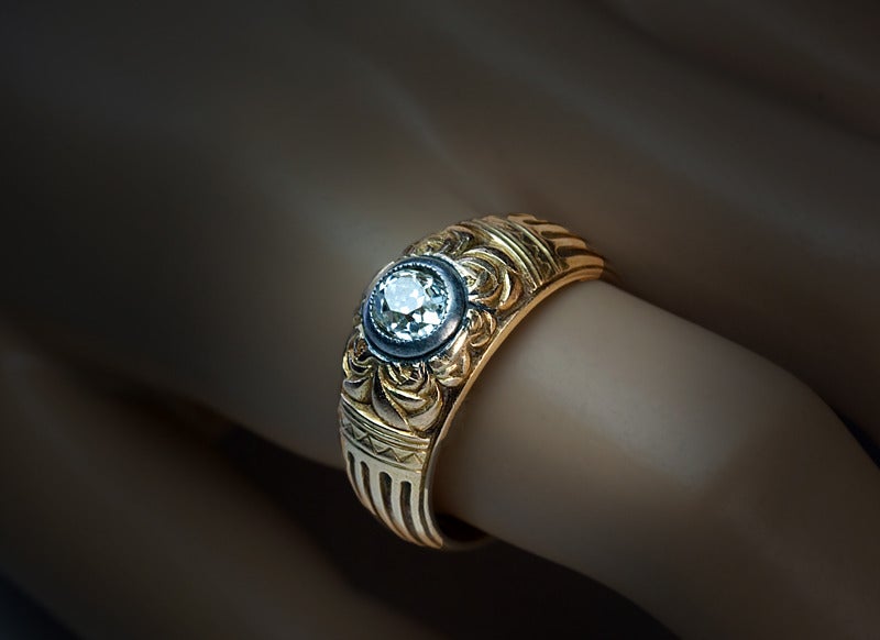 The design of this unique Russian Imperial era greenish yellow gold ring is clearly influenced by the Art Nouveau style of the period. 

Made in Moscow between 1908 and 1917.

The ring is centered with an antique cushion cut diamond (4.75 x 5.7