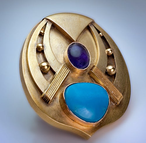 Made in St. Petersburg, circa 1890.

A 14K gold brooch / pin is designed as a stylized horseshoe - a symbol of good luck.  

The brooch is set with an oval cabochon amethyst and irregularly shaped turquoise. 

Marked with 56 zolotnik old