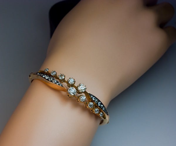 A finely crafted antique Russian gold and diamond crossover bangle bracelet. Polished rose gold, 28 Old European cut diamonds with an approximate total weight of 3.53 ct (the central diamonds - 0.73 ct and 0.67 ct).
The bracelet is marked with