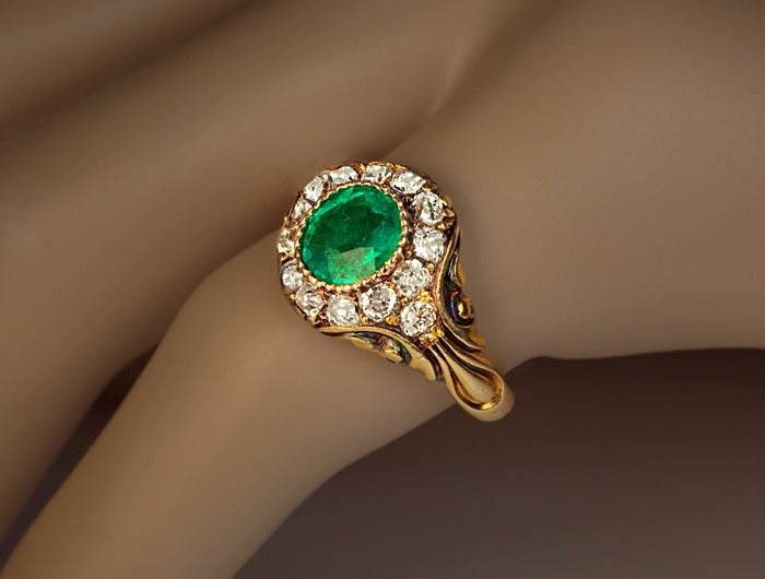 A Victorian Era Emerald and Diamond Gold Ring

circa 1850

This Russian mid 19th century carved gold ring is set with an oval old mine emerald within a sparkling diamond surrounding.

The ring is marked with 56 zolotnik gold standard (14K) and