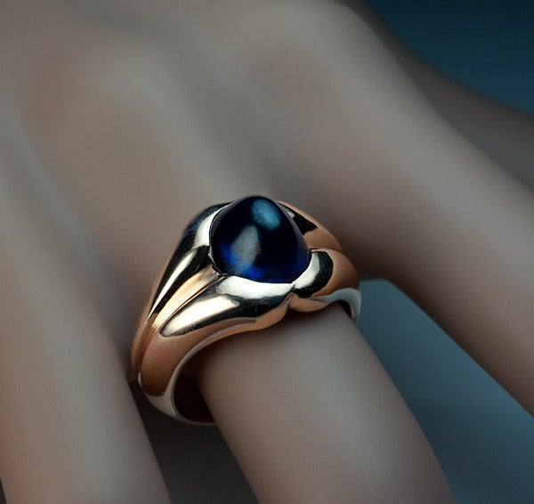 made in Moscow between 1908 and 1917

 A heavy 14K rose gold ring features a cabochon cut blue sapphire (10 x 8.4 x 7.4 mm, approximately 6.71 ct)

 Weight 11.9 grams

 US ring size 6 1/2  (17 mm)

The ring is marked with 56 zolotnik old