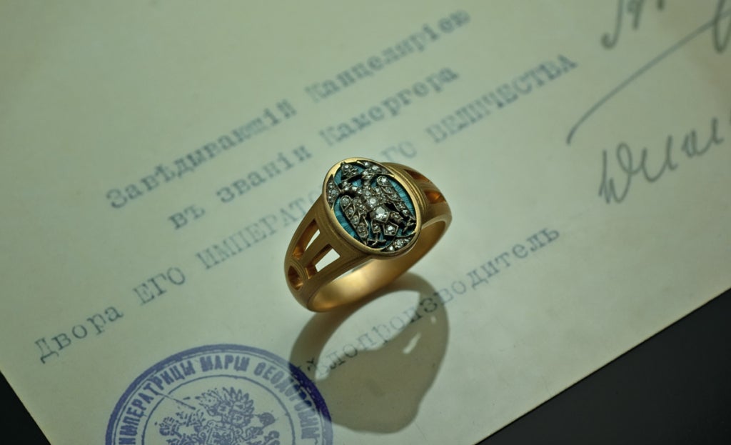A unique Russian Imperial Award men's ring by Faberge, given by the Empress Maria Feodorovna (mother of Tsar Nicholas II) in 1915.  The ring comes with a copy of its original award certificate. The certificate is signed by the head of the Cabinet