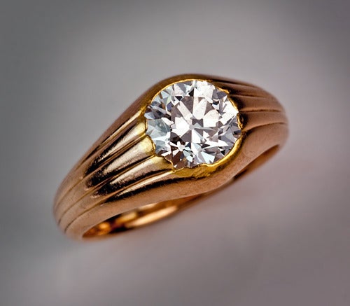 A Faberge Diamond Solitaire Gold Ring

circa 1900

A simple, yet elegantly designed, reeded 14K gold ring is set with a sparking white old European cut diamond.

Reeded patterns were frequently used by Peter Carl Faberge.

The recently