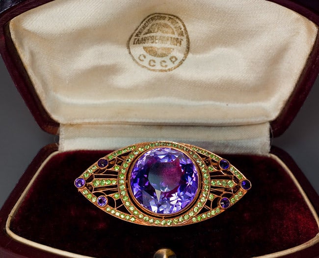 Moscow, circa 1930

A 14K gold milgrain openwork brooch in Art Deco style features a large bright purple sparkling Russian amethyst: 

 20 - 19.5 x 15.6 mm, approximately 29 carats.

The well matched sparkling Ural demantoids are of a uniform