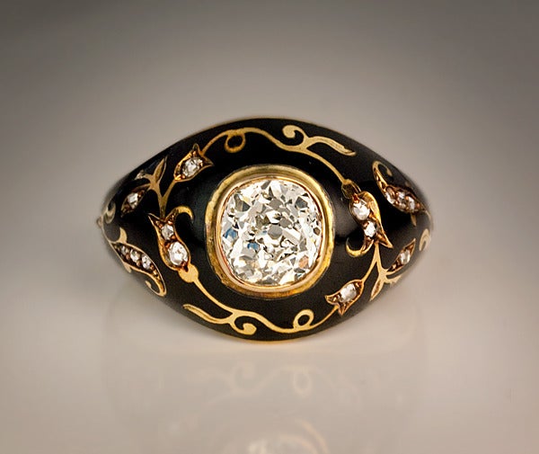 Russian, c. 1910

The 14K gold ring features an antique cushion cut diamond (6.4 x 6.2 x 3.8 mm, approximately 1.25 ct, K-L color, VS1 clarity) surrounded by scrolling gold foliage in oriental taste embellished with rose cut diamonds on a glossy